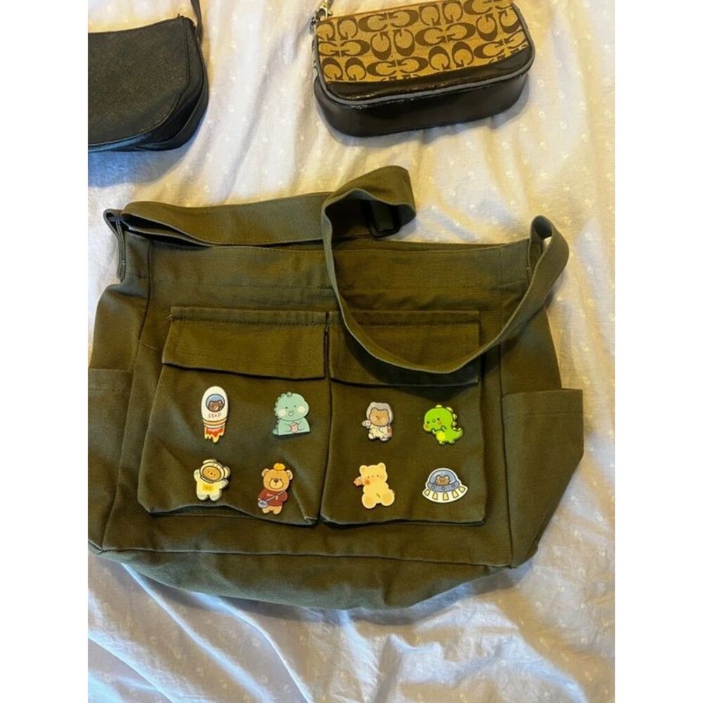 green messenger bag with pins